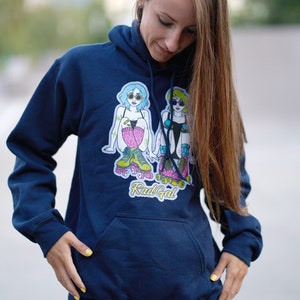 Puede incluir: Una sudadera con capucha azul marino con un gr&aacute;fico de dos mujeres en patines. El gr&aacute;fico incluye el texto "Rad Gal".