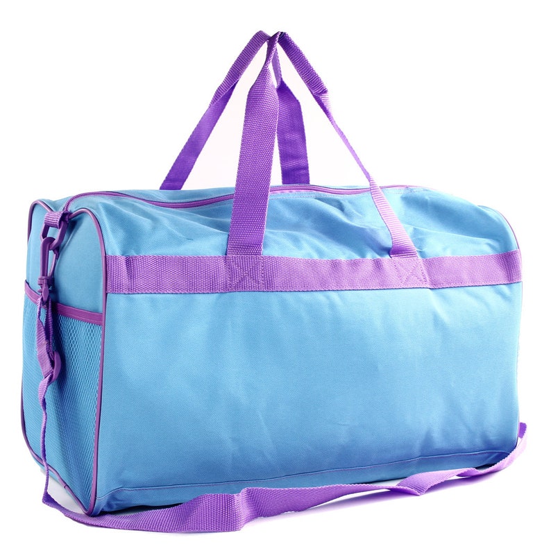 May include: A light blue duffel bag with purple straps and a mesh pocket. The bag has a zipper closure and a shoulder strap.
