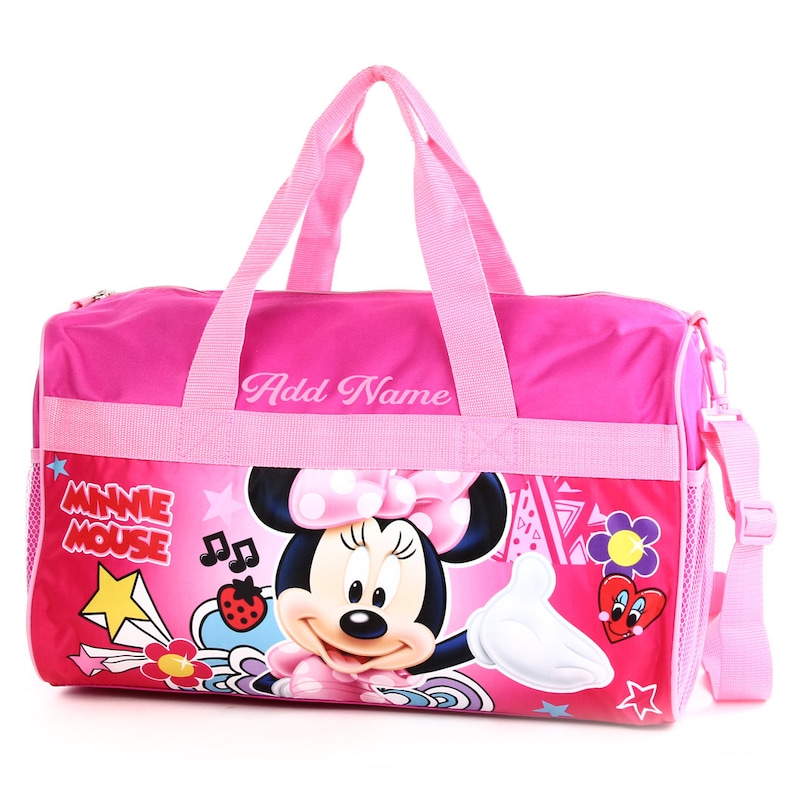 May include: Pink Minnie Mouse themed duffel bag with a zippered main compartment, a mesh side pocket, and an adjustable shoulder strap. The bag features a colorful graphic of Minnie Mouse with the text "Minnie Mouse" and "Add Name".
