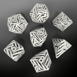 May include: Set of seven white dice with numbers 1 through 6 on each face. The dice are made of a textured plastic and have a unique design with the numbers appearing as if they are woven into the surface.