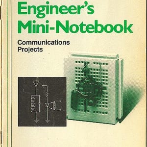 May include: A vintage "Engineer's Mini-Notebook" by Forrest M. Mims III, published by Radio Shack. The cover features green text and a diagram of electronic components. The notebook is designed for communications projects.