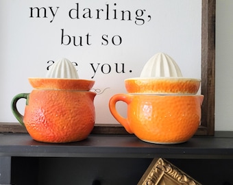 Two Small Orange Ceramic Juicer Reamers
