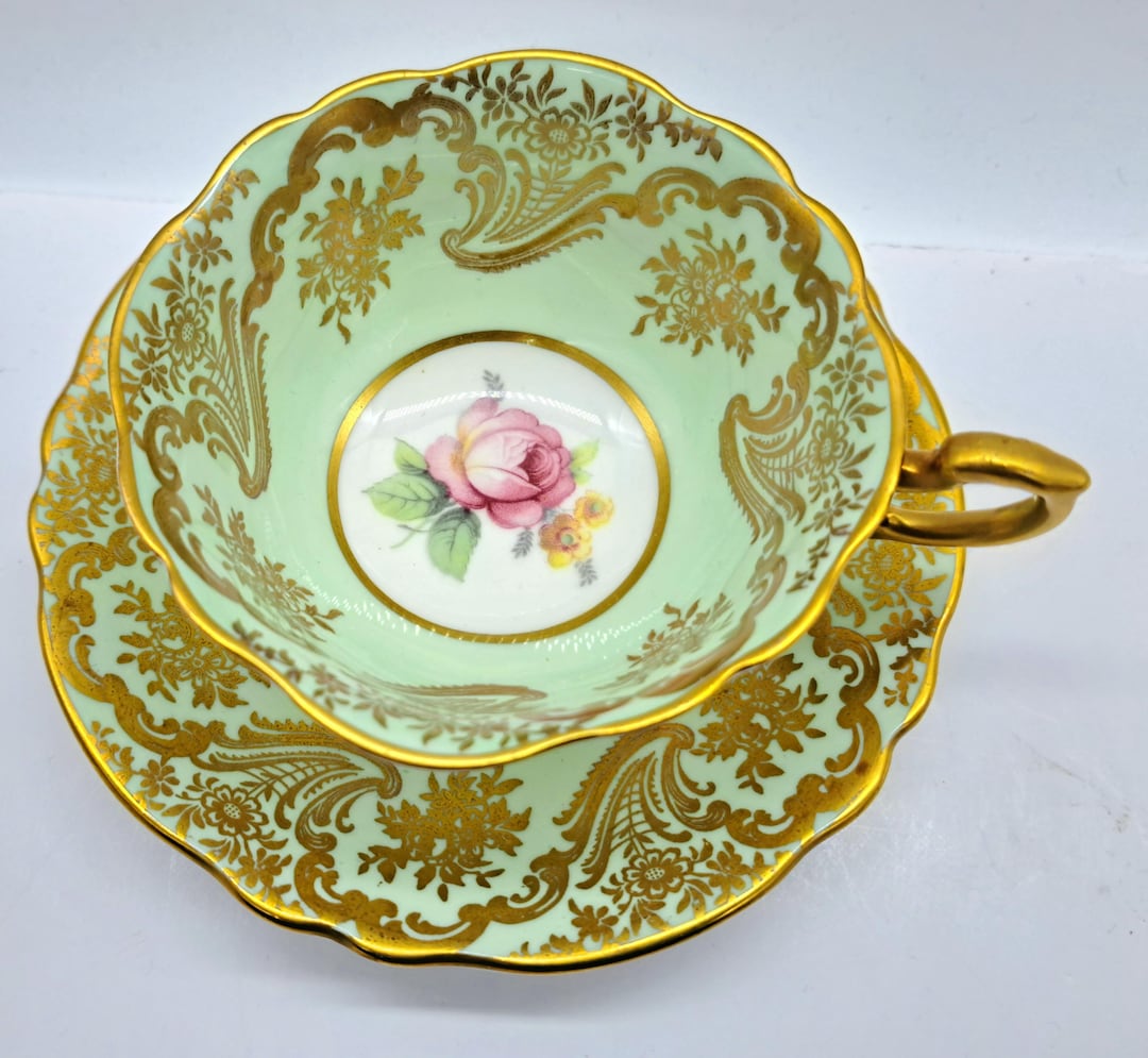Paragon Fine Bone China Teacup & Saucer: Rose Center, Gold Pattern