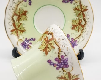 Aynsley corset shaped cup and saucer, garland of grapes and vines , made in England