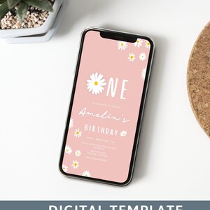 May include: A pink digital invitation with white daisies and the text "One Amelia's Birthday" on a smartphone screen. The invitation includes the date, time, and location of the event.