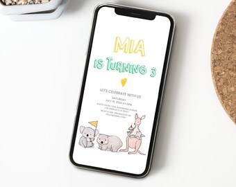 May include: A digital birthday invitation for a girl named Mia turning 3. The invitation features a yellow and green color scheme with a cute illustration of a koala, a wombat, and a kangaroo. The text on the invitation reads "MIA IS TURNING 3" and includes details about the party, including the date, time, and location.
