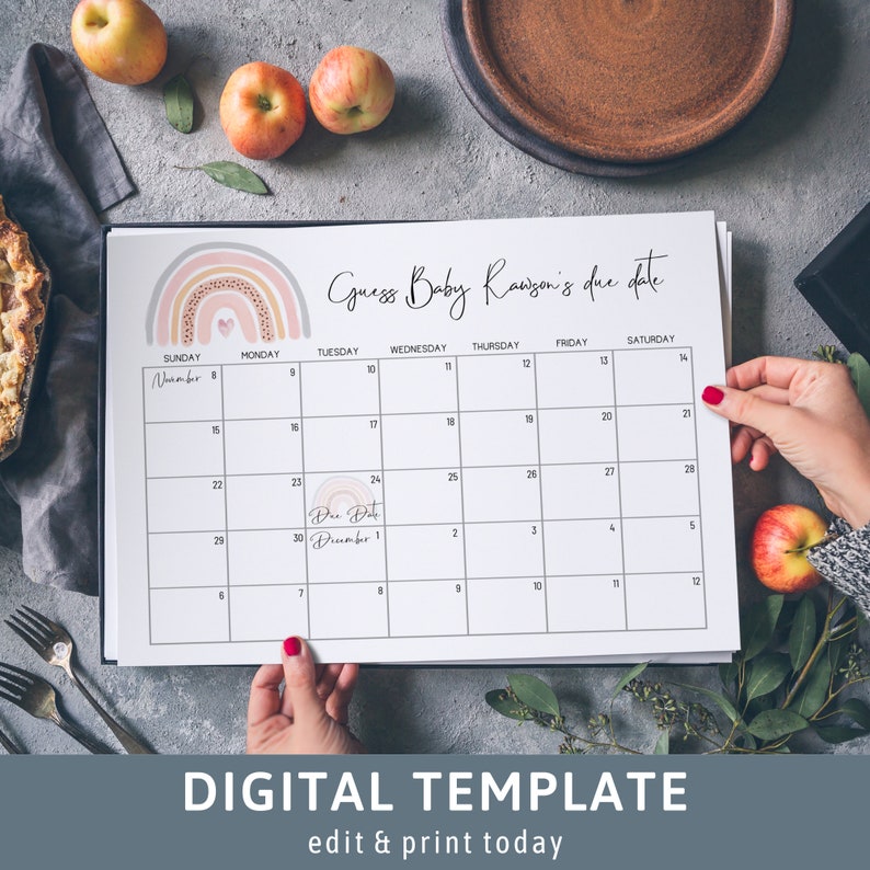Op de afbeelding: Een printbare kalender met een regenboogontwerp en de tekst "Raad de uitgerekende datum van Baby Ranson". De kalender is voor november en december en heeft een cirkel rond 1 december met de tekst "Uitgerekende datum".