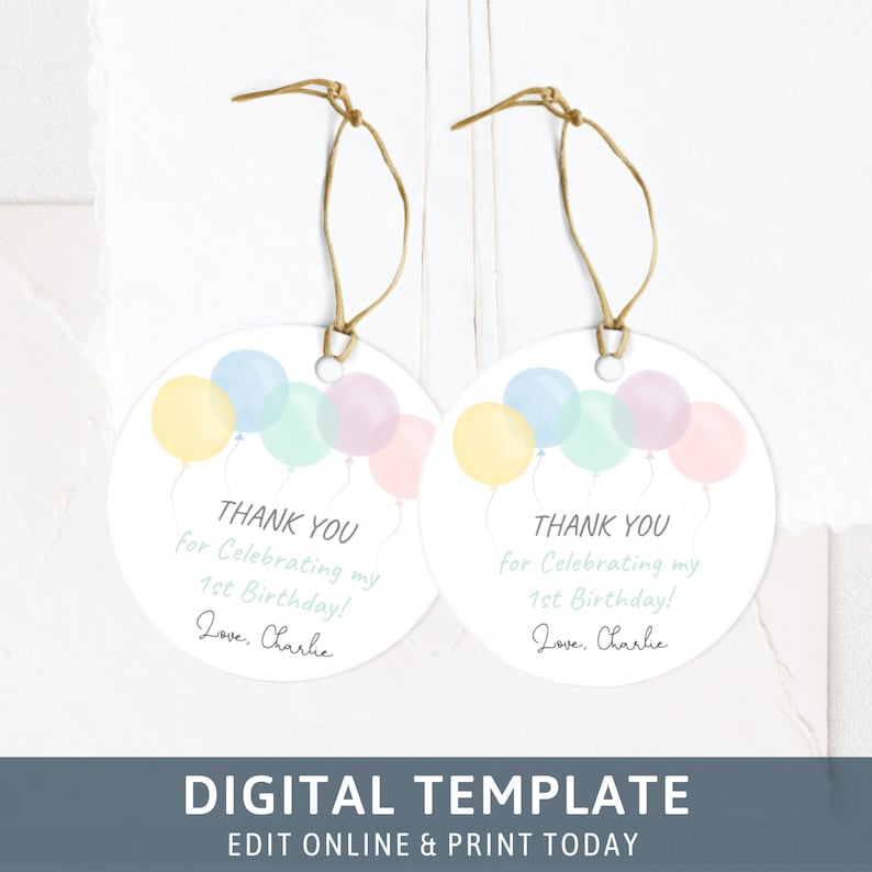 May include: Two round, white thank you tags with a string attached. The tags feature a watercolor illustration of pastel-colored balloons. The text on the tags reads "Thank you for celebrating my 1st birthday! Love, Charlie."