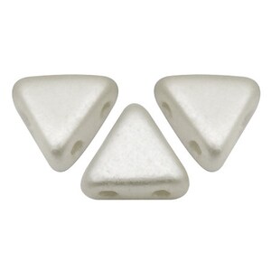 May include: Three white triangle-shaped beads with two holes each.