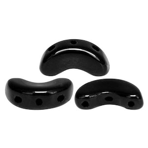 May include: Three black ceramic beads shaped like a crescent moon with three holes each.