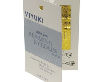 May include: A pack of 6 extra fine Miyuki beading needles with a threader. The pack is white with blue and gold accents. The pack says "MIYUKI extra fine BEADING NEEDLES No. H522/E Contents: 6 Extra Fine Beading Needles with Threader MADE IN JAPAN"