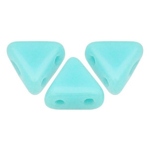 May include: Three turquoise triangle shaped beads with two holes each.