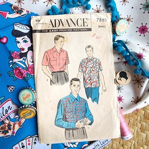 May include: Vintage sewing pattern for men's shirts. The pattern is from Advance, the Easy Printed Pattern, and is for size small. The pattern shows three different shirts, one in pink, one in blue and white plaid, and one in a colourful geometric print. The pattern is on a white background with a blue and white star pattern.