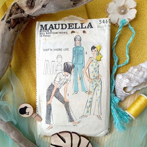 May include: Vintage sewing pattern titled "MAUDELLA BLOUSE & BELL BOTTOM TREWS" with illustrations of 1970s fashion. The pattern features a blue and white color scheme, with the text "SHIP'N SHORE LIFE" and the number "5460".
