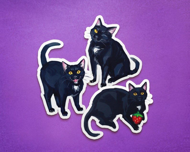 May include: Three black cat stickers with white markings. The cats are in different poses, one is sitting, one is standing, and one is holding a red strawberry.