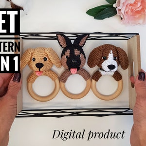 May include: A set of three crochet dog rattle toys. Each toy features a different breed of dog: a golden retriever, a German Shepherd, and a beagle. The toys are attached to wooden rings.