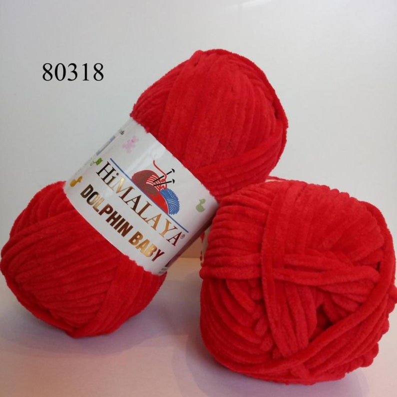 May include: Two balls of red yarn labeled "HIMALAYA DOLPHIN BABY" yarn.