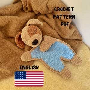 May include: Crochet pattern PDF for a sleeping brown and blue dog amigurumi toy. The pattern is in English and includes an American flag.