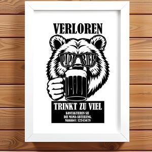 May include: Framed black and white print. It features a bear wearing sunglasses with the words "Papa Bier" and holding a beer stein. The text above the bear reads "VERLOREN" and below reads "TRINKT ZU VIEL".
