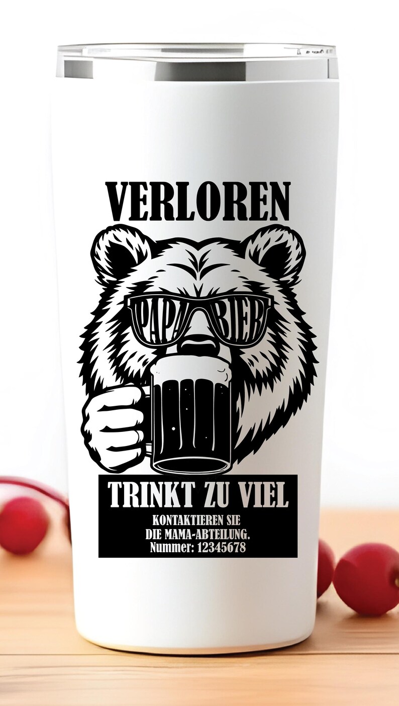 May include: White travel mug featuring a black bear graphic wearing sunglasses and holding a beer stein. The mug has German text: "VERLOREN" and "TRINKT ZU VIEL". A humorous gift for beer enthusiasts. The mug is suitable for hot or cold drinks.