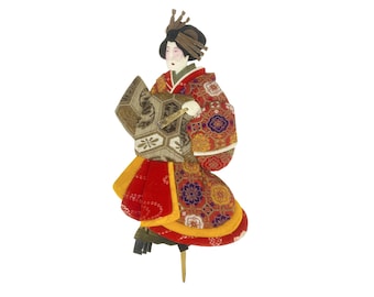 May include: A traditional Japanese doll wearing a red, gold, and black patterned kimono. The doll is holding a fan and is standing on a wooden base.
