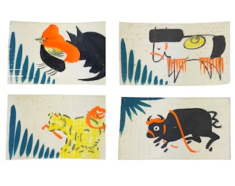 May include: Four rectangular art prints featuring colorful, stylized animal illustrations. The images include a rooster, a cow, a bull, and a yellow creature, each set against a cream background with blue and orange accents.