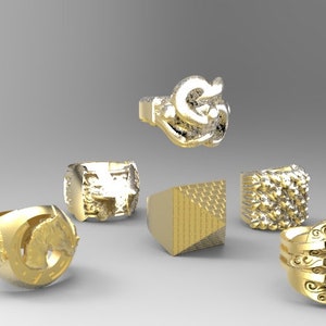 May include: Six gold rings with different designs. The rings feature various textures and patterns, including a geometric design, a textured surface, and a detailed animal figure.
