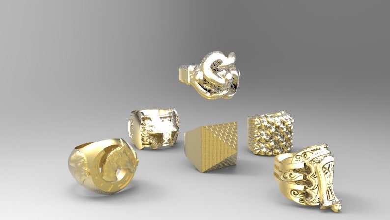 May include: Six gold rings with different designs. The rings feature various textures and patterns, including a geometric design, a textured surface, and a detailed animal figure.