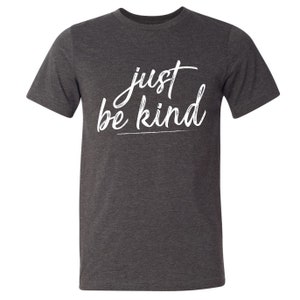May include: A dark heather grey t-shirt with the text "just be kind" in white lettering.