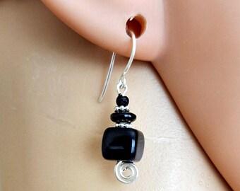 May include: Black onyx dangle earrings with silver beads and a silver wire swirl detail.