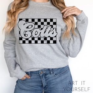 May include: A gray sweatshirt with a black and white checkered design and the word "Colts" in a retro font.
