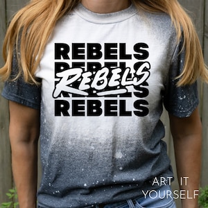 May include: A white and gray ombre t-shirt with the word "REBEL" printed three times in black. The shirt has a distressed look with white speckles throughout.