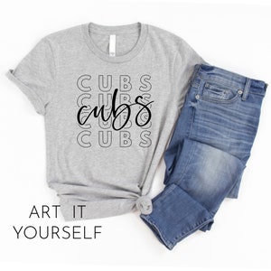 May include: A gray t-shirt with the word "CUBS" repeated in a stacked pattern, with a cursive "cubs" overlay. The shirt is paired with blue jeans. The phrase "ART IT YOURSELF" is printed at the bottom.
