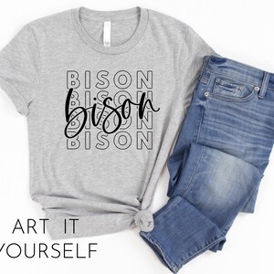 May include: Grey t-shirt with the word "Bison" repeated in black lettering, stacked on top of each other. The word "Bison" is written in a stylised font with a curved "B" and a swirly "S".
