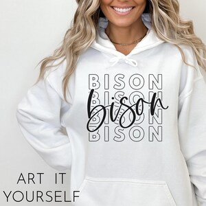 May include: White hooded sweatshirt with the word "Bison" repeated in a stacked pattern, with the middle "Bison" written in a cursive font.