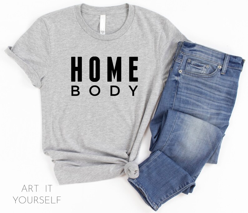 May include: A gray t-shirt with black text that reads "HOME BODY".