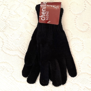 May include: A pair of black chenille gloves with an "EXTRA Soft" tag attached. The gloves are made of a soft, plush material and are designed for warmth and comfort. The tag reads "chenille GLOVE".