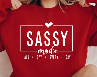 May include: Red sweatshirt with white text that reads "SASSY mode ALL DAY EVERY DAY" with a small heart above the word "SASSY".