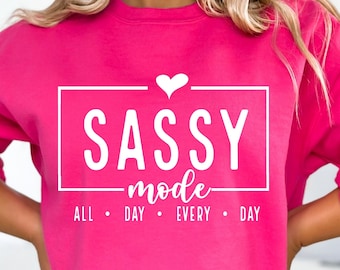 May include: Pink sweatshirt with white text that reads "SASSY mode ALL DAY EVERY DAY" with a small heart above the word "SASSY".