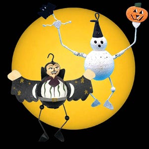 May include: A whimsical Halloween-themed artwork featuring two animated figures against a large yellow moon. One figure is a vampire with outstretched bat-like wings, and the other is a snowman holding a jack-o'-lantern. The background is solid black.