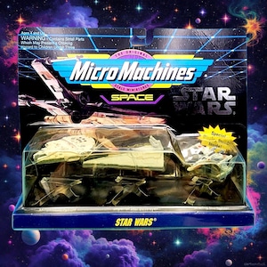 May include: A Micro Machines Star Wars toy set in its original packaging. The package features a blue and black design with the Star Wars logo and the text "Micro Machines." The set includes miniature spacecraft models.