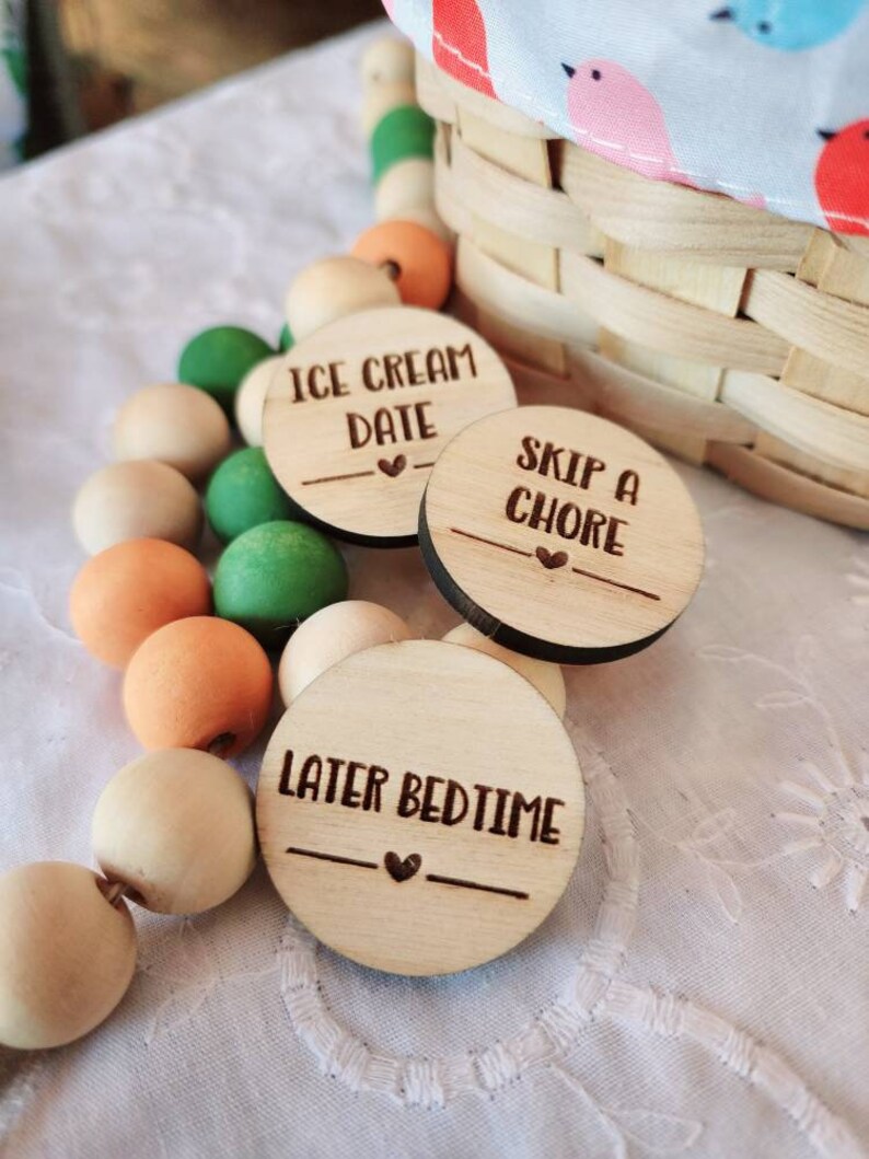 May include: Three wooden circles with different phrases written on them. The phrases are "Ice Cream Date", "Skip a Chore", and "Later Bedtime".