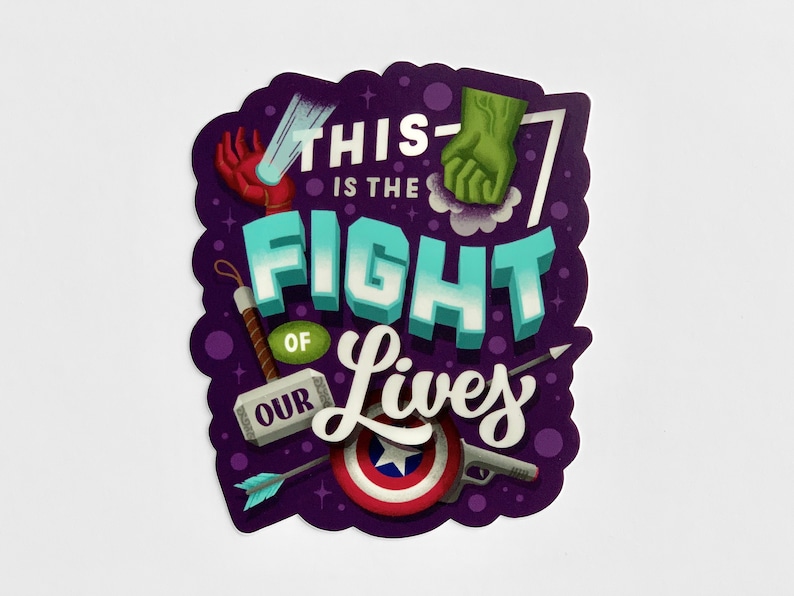 May include: Purple sticker with the text "This is the fight of our lives" in a colorful, 3D style. The sticker features various superhero-themed icons, including a fist, a hammer, an arrow, and a shield.