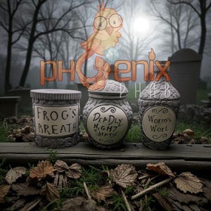 May include: Three gray, decorative jars with labels reading "Frog's Breath", "Deadly Night Shade", and "Worm's Wort". The jars are on a wooden surface with a graveyard background. The jars have a stone-like texture.