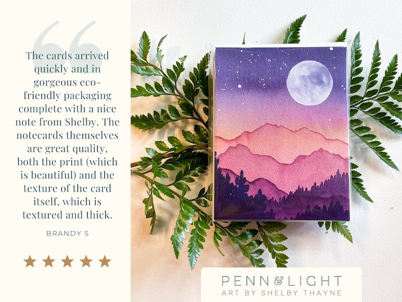 May include: A rectangular greeting card featuring a watercolour illustration of a mountain range at night under a full moon. The scene transitions from a dark purple sky with stars to pink and purple layered mountains and dark purple pine trees.