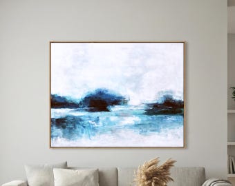 May include: Abstract landscape painting with a gold frame. The artwork features a serene scene with shades of blue, white, and brown. The brushstrokes create a sense of depth, depicting a body of water and a cloudy sky.