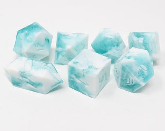 May include: Set of seven polyhedral dice with a marbled turquoise and white design. The dice are various shapes, including a d4, d6, d8, d10, d12, and d20. The dice are made of a translucent material.