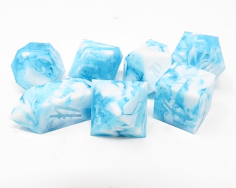 May include: Set of six blue and white marbled dice. The dice are made of resin and have a swirling pattern of blue and white.