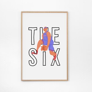 May include: A framed print featuring a basketball player in a blue uniform, holding a basketball, jumping over the words "THE SIX" in black block letters. The player is wearing red shoes and a blue headband.