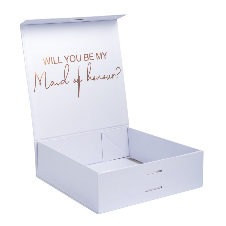 May include: A white gift box with a lid that is open. The lid has the words "Will you be my Maid of honour?" printed in gold foil.
